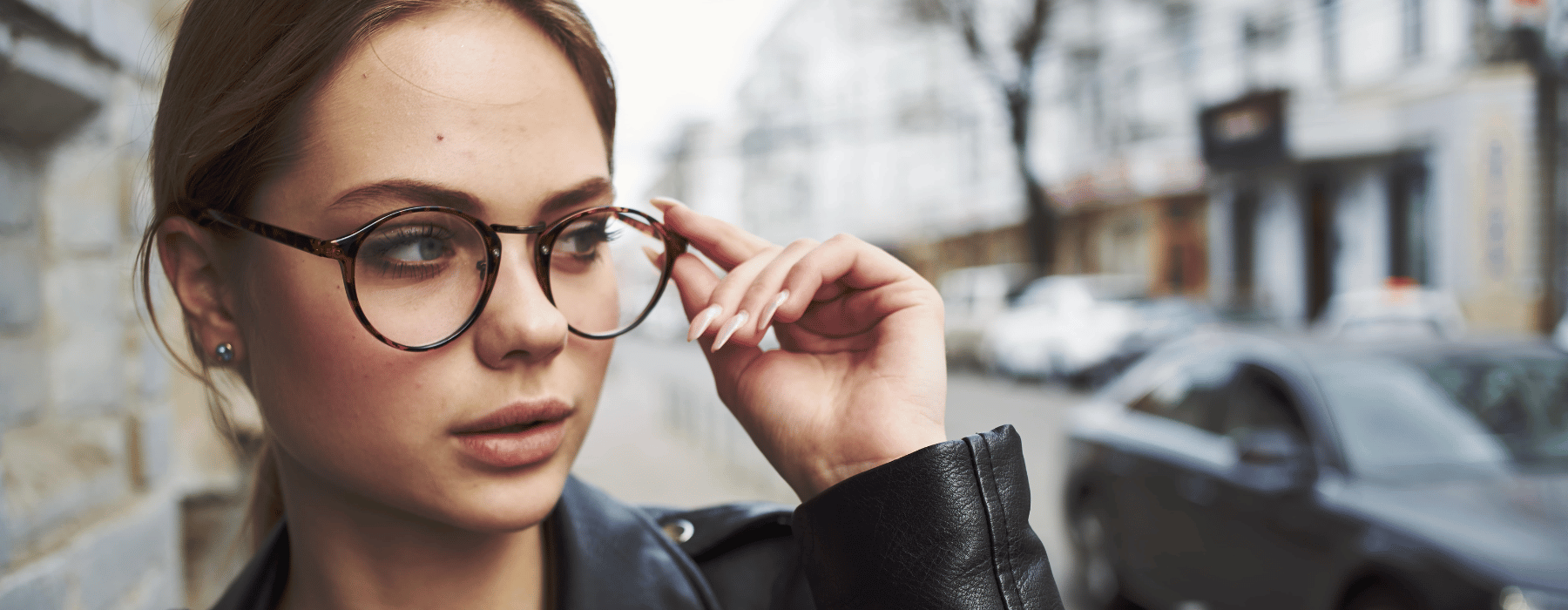 Designer Brands: Young Woman Holding Her Glasses